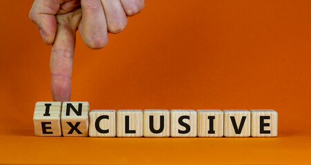 Symbol for a better inclusion. Male hand turns cubes and changes word exclusive to inclusive. Beautiful orange background. Copy space. Concept.
