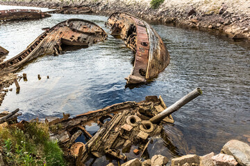 Sunken old wooden fishing boats in Teriberka, Murmansk Oblast, Russia