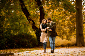 Fototapeta premium Young couple walking in the autumn park