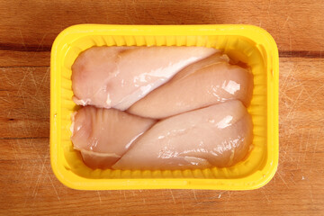 Chicken breast in disposable plastic packing box. Directly Above.