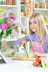 Portrait of cute girl preparing fresh salad