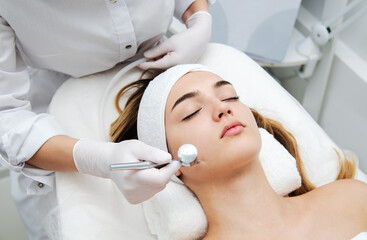Woman getting face beauty treatment in medical spa center. - 393631173