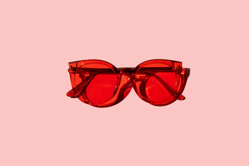 Trendy modern red sunglasses on pink background