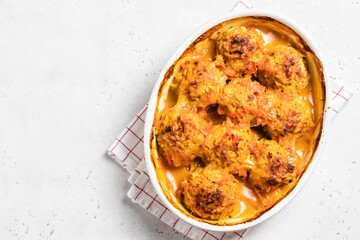 Italian turkey meatballs in a baking dish. Space for text, top view.
