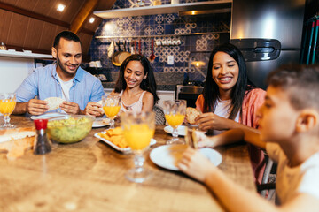 Latin family having dinner at home