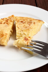 Eating Spanish omelette. Macro.