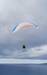 Paragliding flying over the sea in the mountains in southern Sardinia
