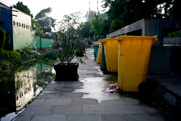Row of garbage bins lined up along the park