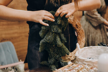Woman making christmas wreath. A Christmas wreath made with your own hands.