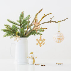 modern Christmas sill life in jug with snowman on white background