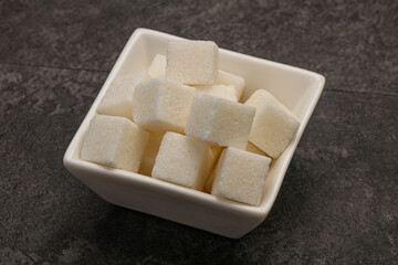 Refined white sugar cubs in the bowl
