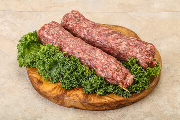 Raw minced beef kebab skewer
