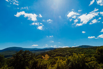 beautiful landscape of mountains green forest and blue sky with clouds