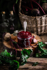 Homemade beet ketchup in a glass jar. Rustic style