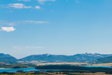 beautiful landscape of mountains green forest and blue sky with clouds