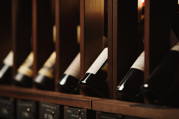 Wine cellar with elite drinks on shelves with written names