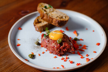  Beef tartar dish with tasty vegetables.