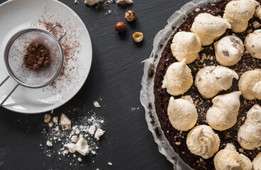 Chocolate cake with hazelnuts and meringues, top view