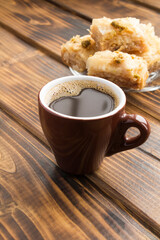 Closeup on turkish coffee and delight on the wooden table. Location vertical.