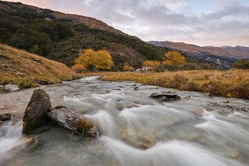 Fototapeta na wymiar River flowing in Autumn. Rees Valley, South Island, New Zealand.
