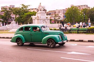green classic car on the streets of havana cuba - obrazy, fototapety, plakaty
