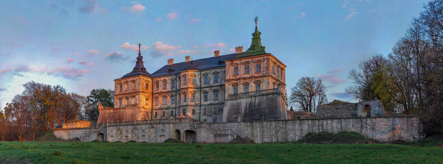 Sunset light illuminates the ancient Pidhirtsi Castle, Lviv region, Ukraine