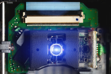 Close-up of a laser lens for reading and writing dvd roma cd drive. Readout optical design