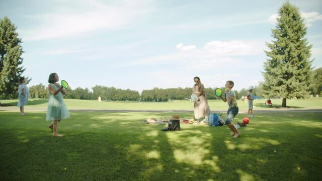 Children throw ball tennis, family, park, leisure, variety, grass greens, multinational