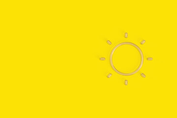 Sun 3D Rendering. Concept of Sun Protection, Vitamin D and Omega 3 Pills on Yellow Background with Copy Space.