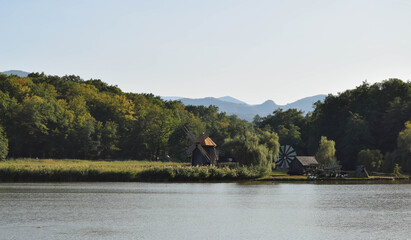 Traditional romanian windmill by the lake. Shot in a rural part.
