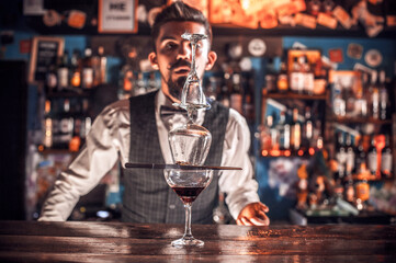 Bartender makes a cocktail on the brasserie