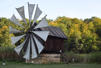 Old historic windmill with sails in Sibiu, Transilvanya. Traditional rustic mill in the countryside.