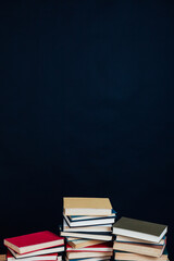 stacks of books for education in the library on a black background place for inscription