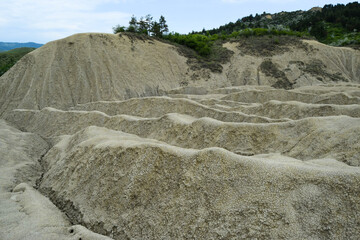 Landscape with cracked soil. Ground shape created by muddy volcanoes and natural-gas eruptions in...