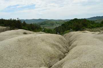 Landscape with cracked soil. Ground shape created by muddy volcanoes and natural-gas eruptions in...