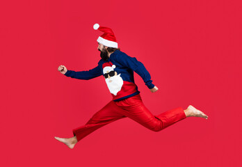 Fototapeta na wymiar Christmas time. feel free. happy new 2021 year. merry christmas. xmas party fun. happy bearded man hipster wear red festive elf costume. mature santa claus jumping. funny winter holiday celebration