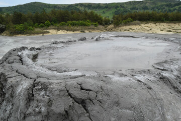 Bubbling crater of a mud volcano. Close up view onto gas bubble exploding in crater of mud volcano. Mud volcano at Paclele Mari, near Buzau, Romania.