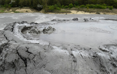 Bubbling crater of a mud volcano. Close up view onto gas bubble exploding in crater of mud volcano. Mud volcano at Paclele Mari, near Buzau, Romania.