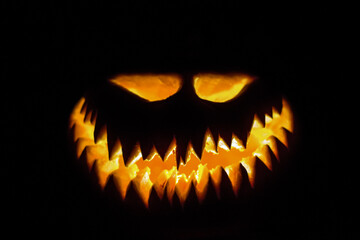 Halloween pumpkin glowing face in the dark.