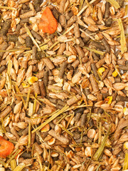 basic muesli  with herbs background for horse . close up