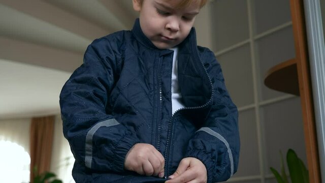 Child Zipping Fastens his Jacket with a Zipper. Little Boy Wearing Winter Attire Zipping with Zip-fastener. 2x Slow motion 60 fps 4K