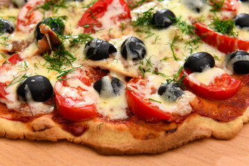 homemade pizza, vegetarian food, baked vegetables and cheese, tomatoes and olives, delicious food on a wooden background