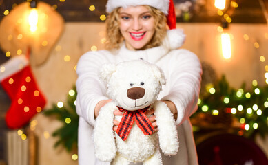 Plan for some interesting Christmas activity. Things to do before christmas. Plan where and how you are going to spend new year eve. Woman with teddy bear toy christmas decorations background