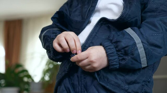Child Zipping Fastens his Jacket with a Zipper. Little Boy Wearing Winter Attire Zipping with Zip-fastener. 2x Slow motion 60 fps 4K