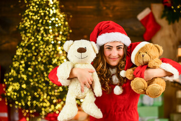 Fototapeta na wymiar christmas party. christmas day is celebrated. new year tips and ideas. happy girl at xmas party. christmas shopping sales. happy santa woman bear toy present. at the toy shop. decorate your holiday