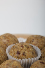 Dried fruit and oatmeal sweets. On a white surface. Close-up shot.