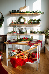 the kitchen is decorated with fir branches garland and toys, Christmas interior decor, cozy space for cooking, kitchen area