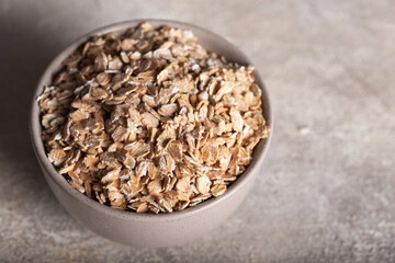 flakes in a bowl on wooden table