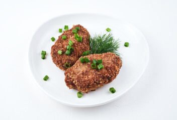 Culinary background with two fresh juicy cutlets on a white background. Side view with space for copying. Home-cooked food concept.