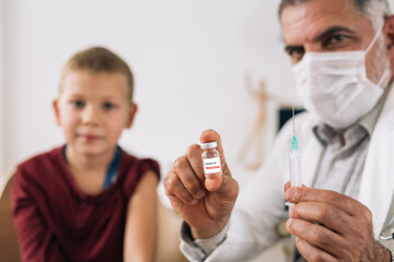 doctor holding covid-19 vaccine